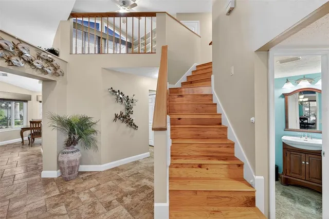 a spacious bedroom with a bed and a chandelier