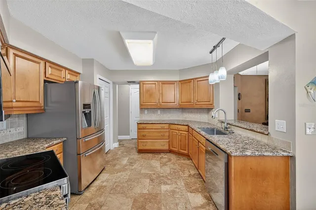 a view of a dining room with furniture a chandelier and wooden floor