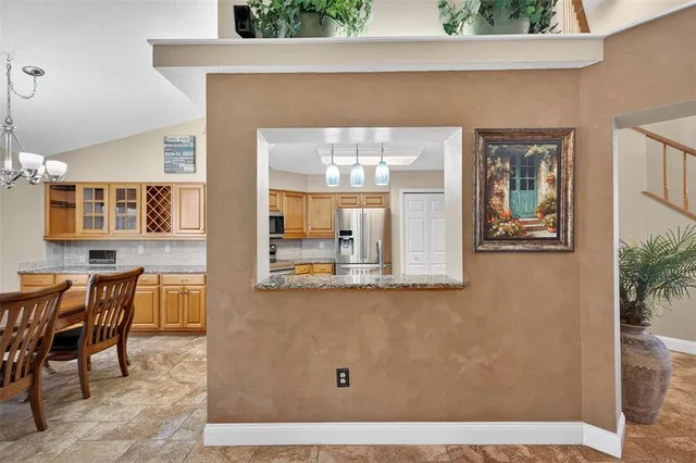 a living room with furniture a chandelier fan and a window