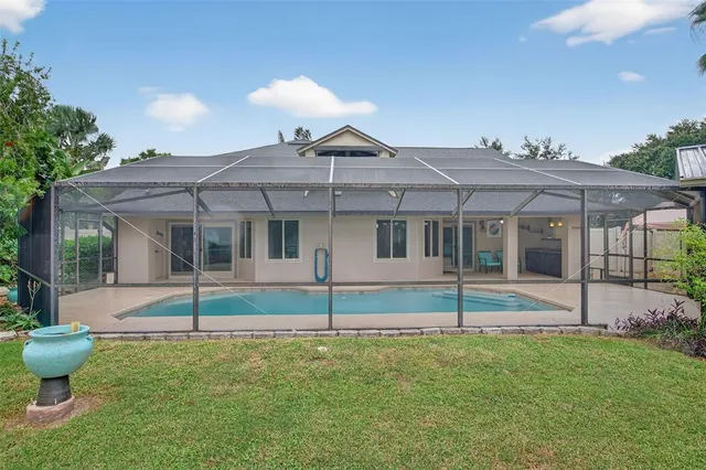 a view of a house with a yard and sitting area