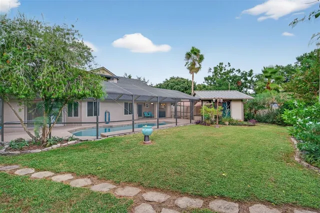 a view of a house with a small yard and floor to ceiling window