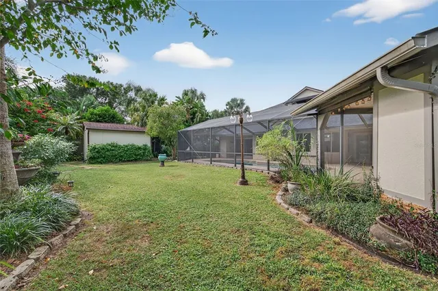 a view of a patio with table and chairs and a barbeque