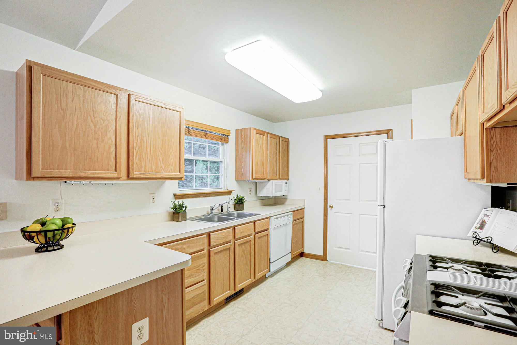 230 Tina Marie Lane Smyrna, DE 19977 - Photo 30 of 83 a kitchen with a sink stove and cabinets