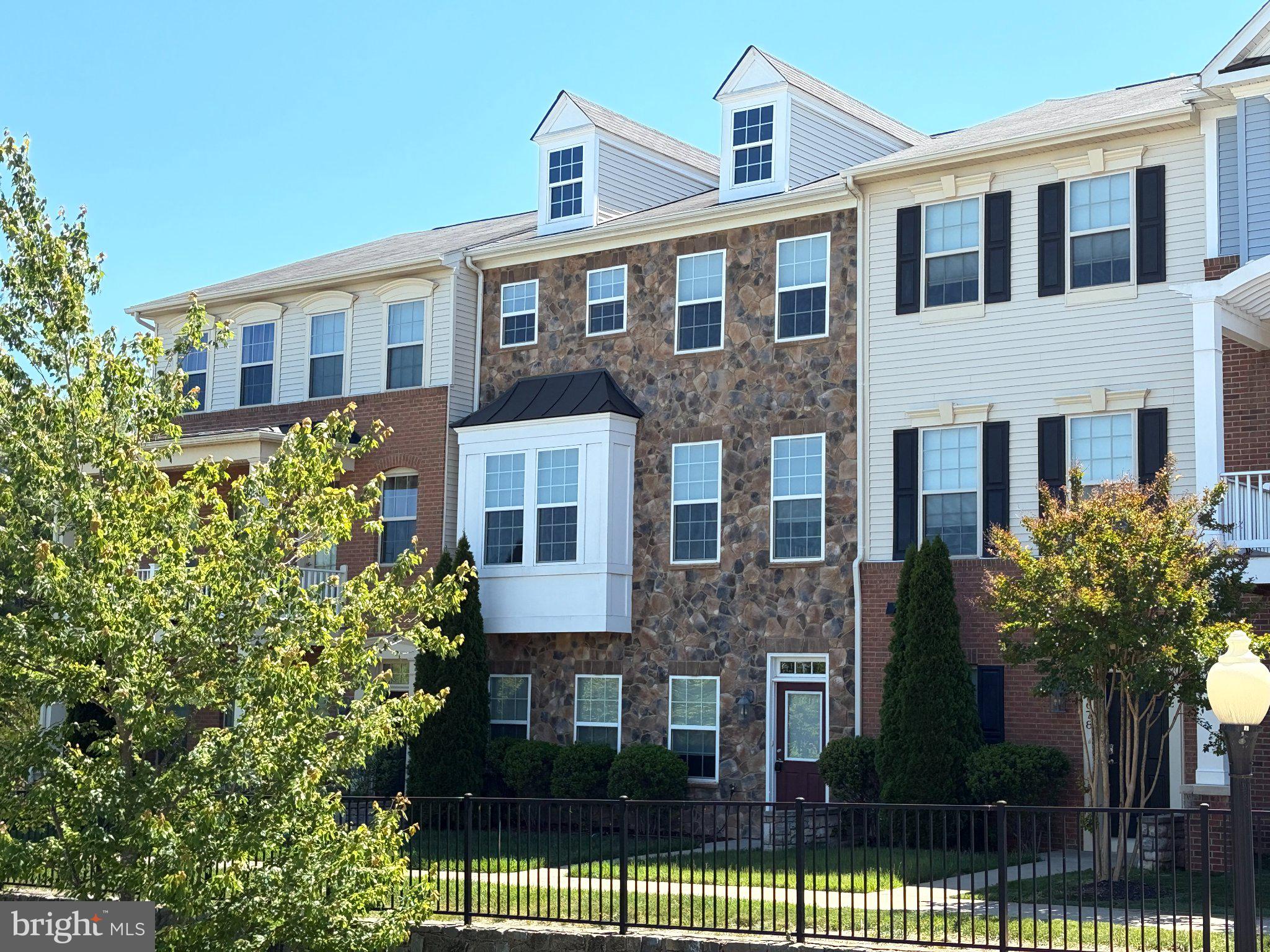 Charming townhouse with stone accents.