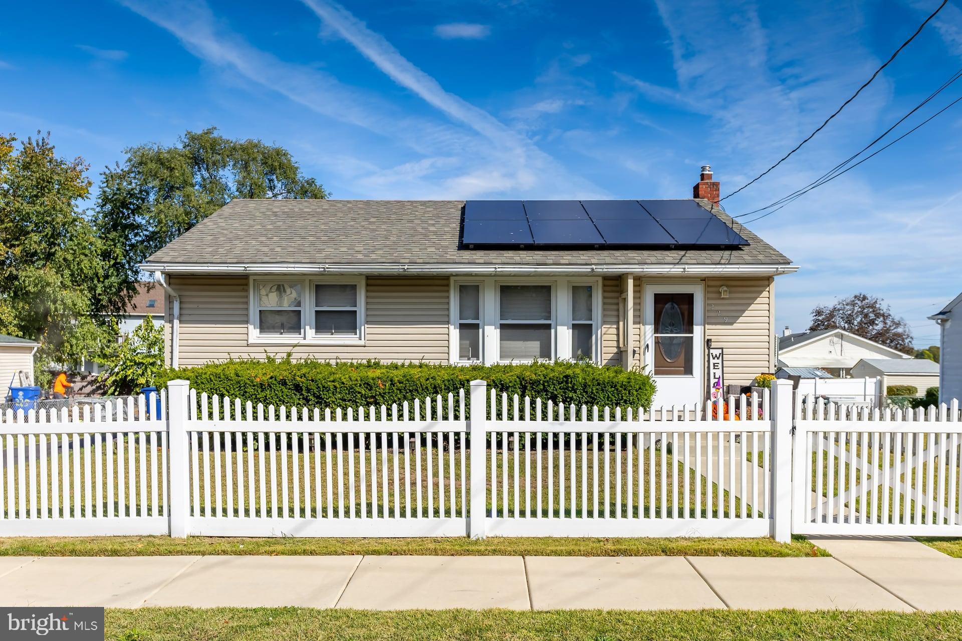 a front view of a house with a garden and deck