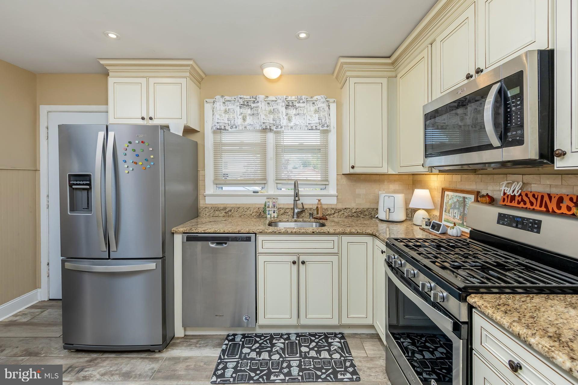 229 Filmore Street Riverside, NJ 08075 - Photo 7 of 18 a kitchen with stainless steel appliances granite countertop a stove a sink and a refrigerator