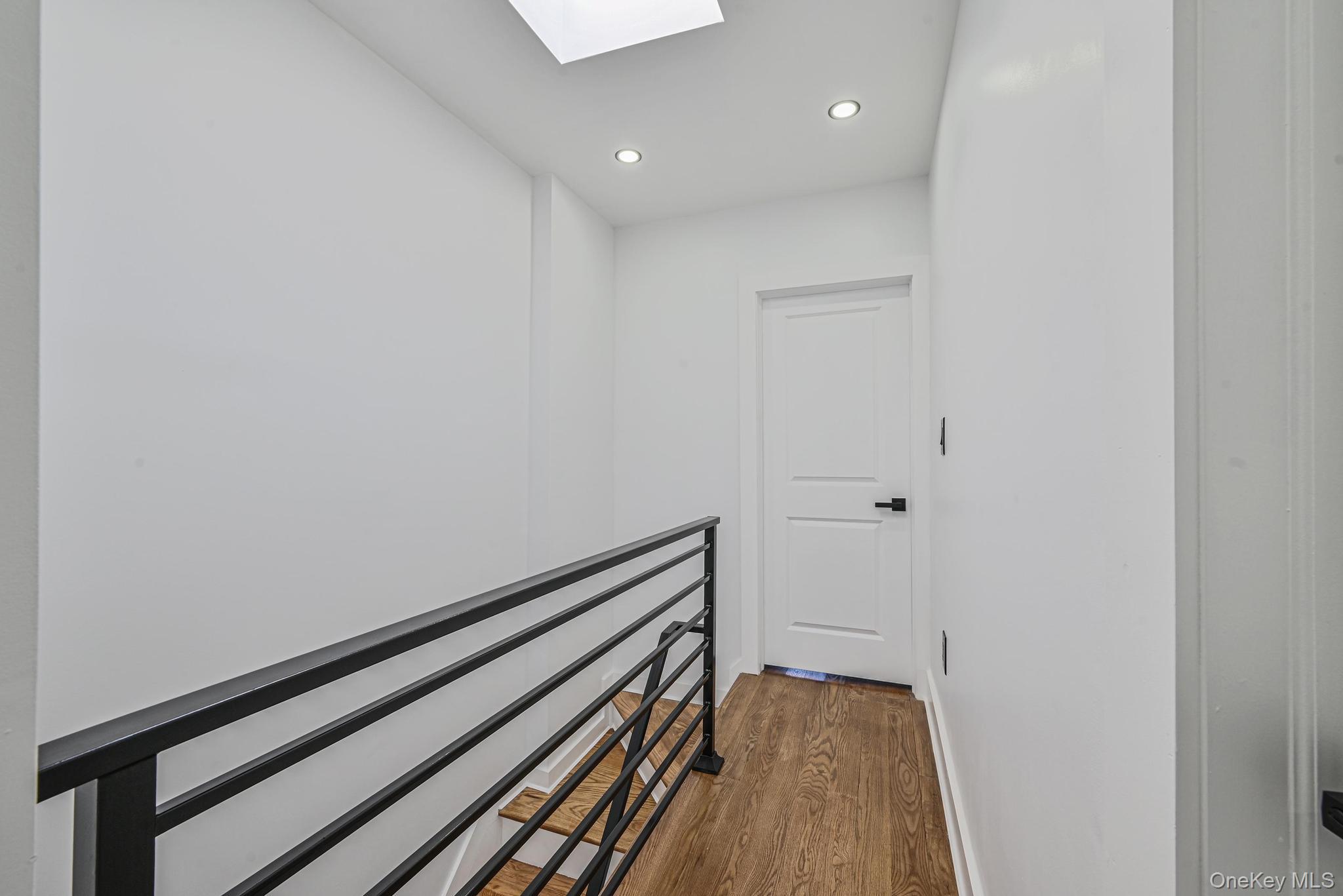 92-43 76th Street Queens, NY 11421 - Photo 14 of 20 Hallway with a skylight, dark wood-style floors, and recessed lighting