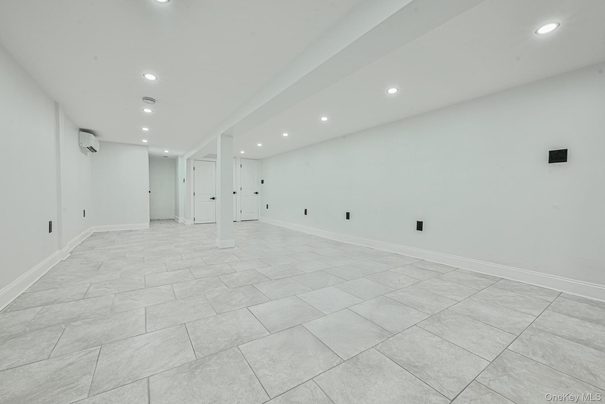 92-43 76th Street Queens, NY 11421 - Photo 20 of 20 Spare room featuring recessed lighting and a wall mounted AC