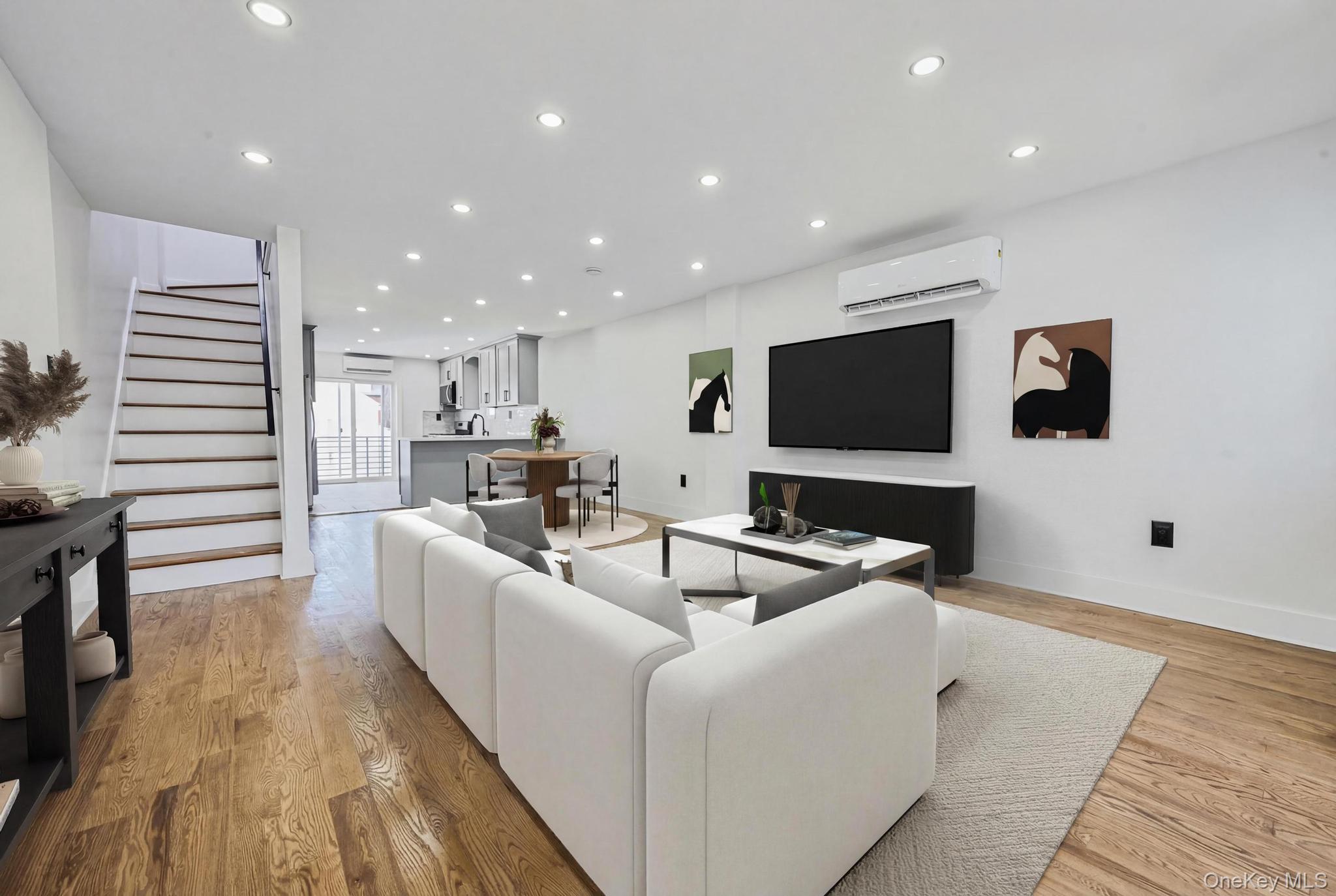 92-43 76th Street Queens, NY 11421 - Photo 3 of 20 Living area with stairway, recessed lighting, light wood-type flooring, and a wall mounted air conditioner