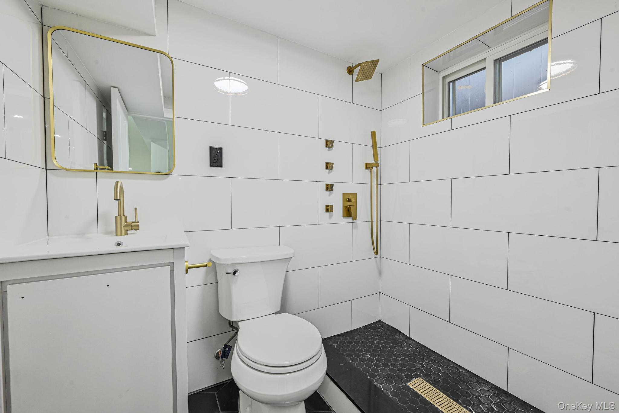 92-43 76th Street Queens, NY 11421 - Photo 4 of 20 Bathroom featuring tile walls, a tile shower, and vanity