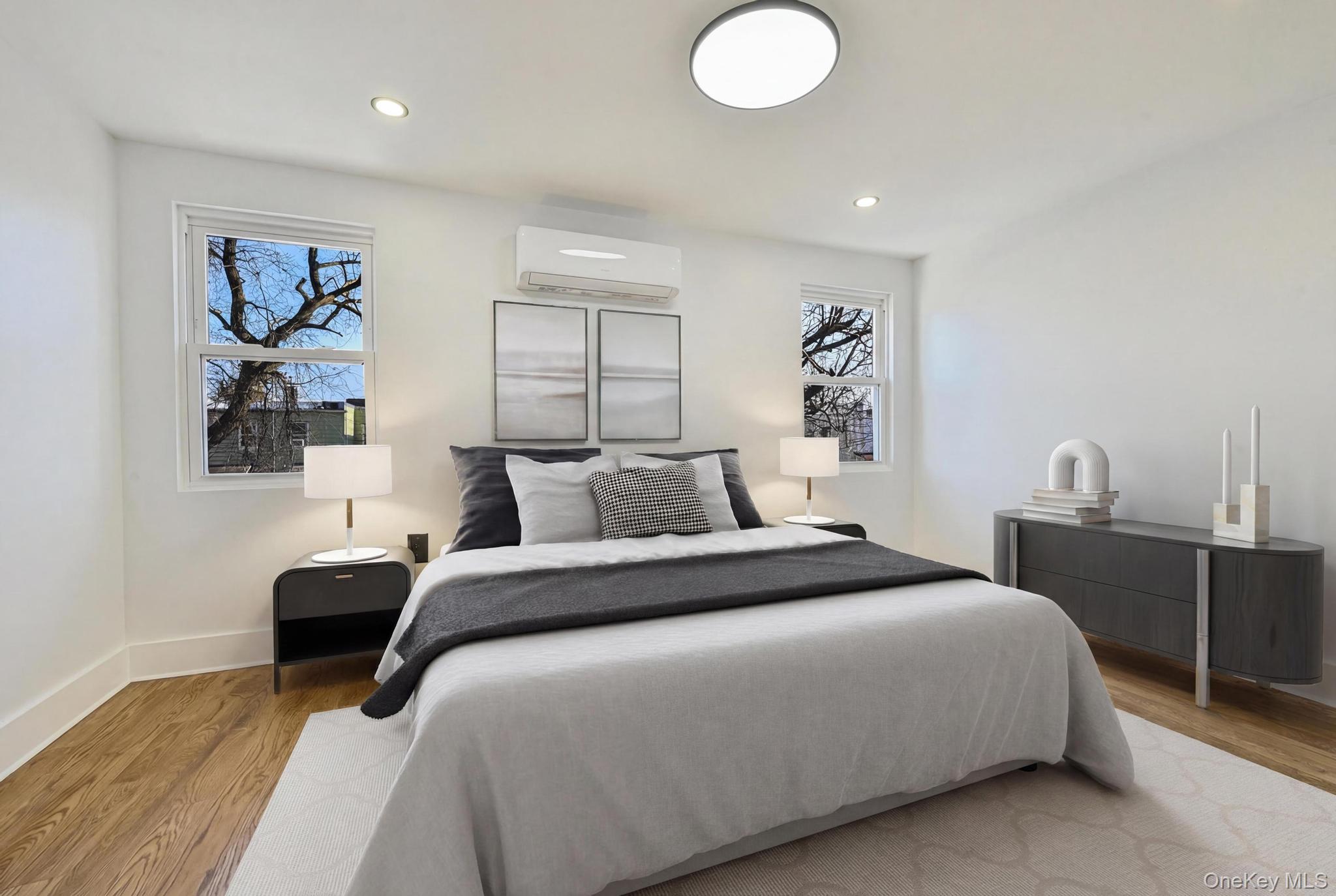 92-43 76th Street Queens, NY 11421 - Photo 9 of 20 Bedroom with light wood-style floors, a wall mounted AC, and recessed lighting