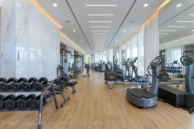 a room with gym equipment and a large mirror