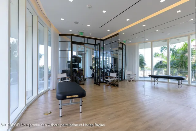 a view of a room with gym equipment and floor to ceiling window