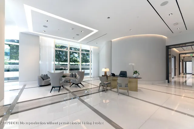 a living room with furniture and large windows