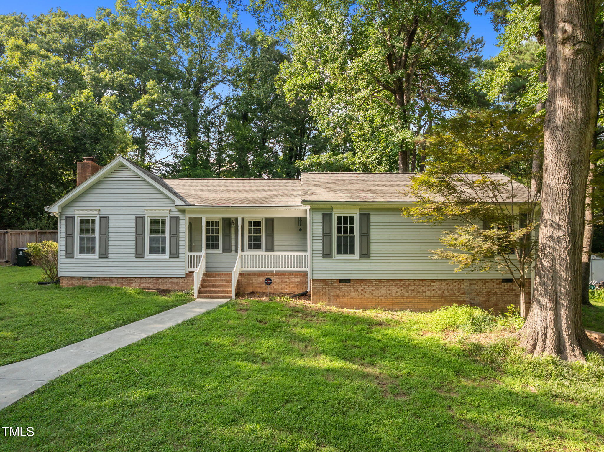 219 Barclay Road Durham, NC 27712 - Photo 1 of 36 a front view of a house with a yard and trees