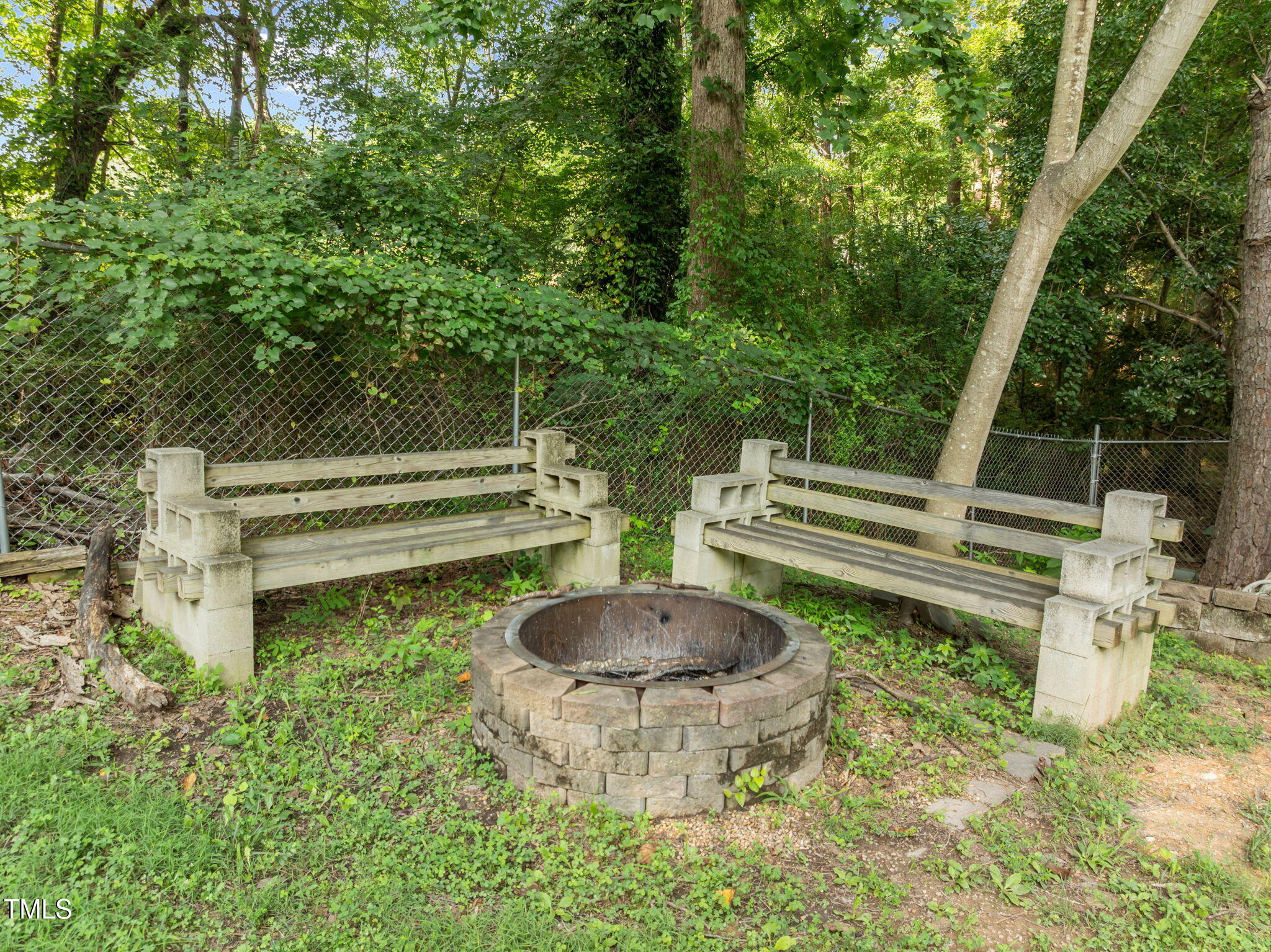 219 Barclay Road Durham, NC 27712 - Photo 29 of 36 a view of a chair and fire pit in a garden