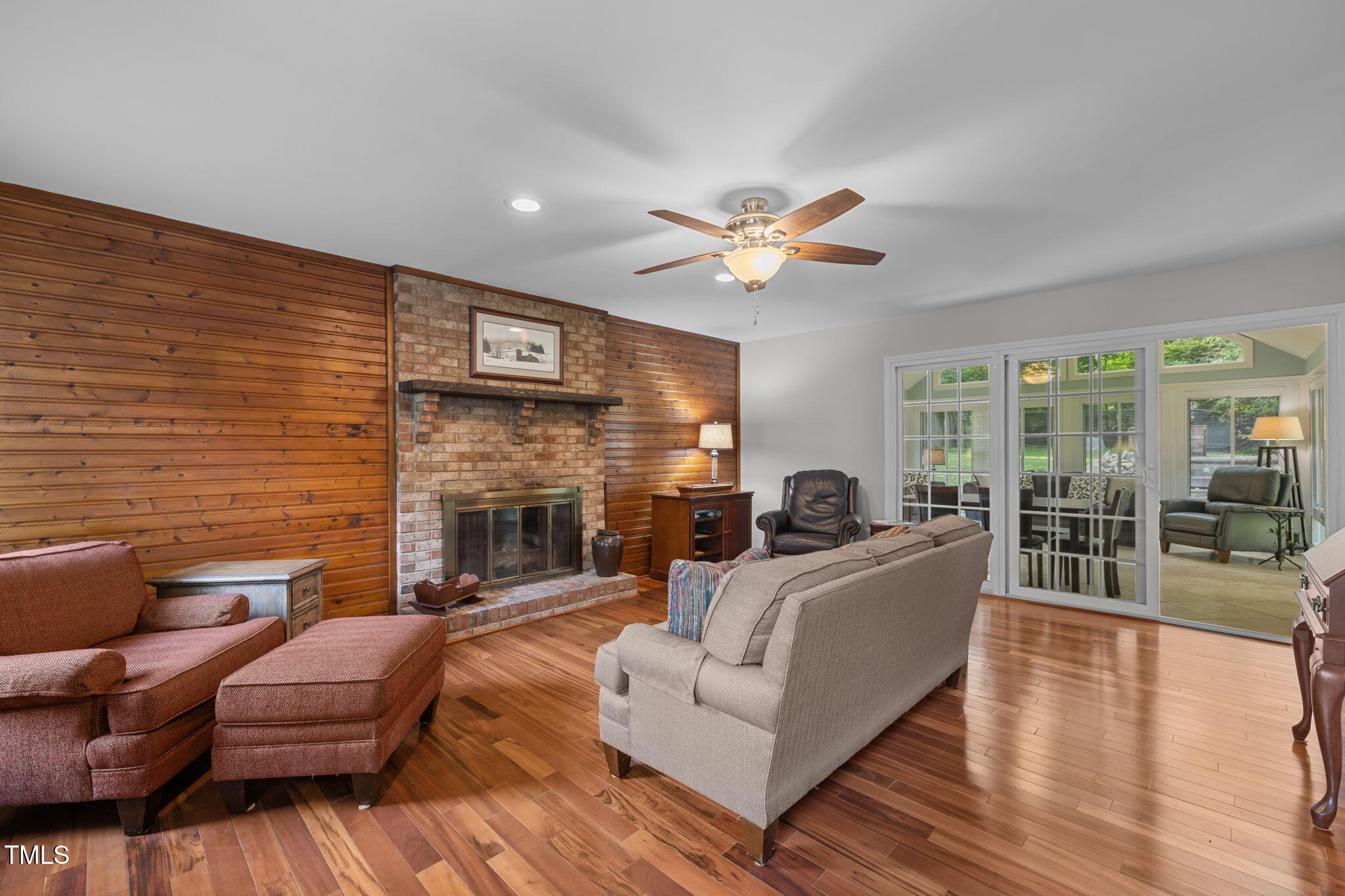 219 Barclay Road Durham, NC 27712 - Photo 3 of 36 a living room with furniture wooden floor and a fireplace