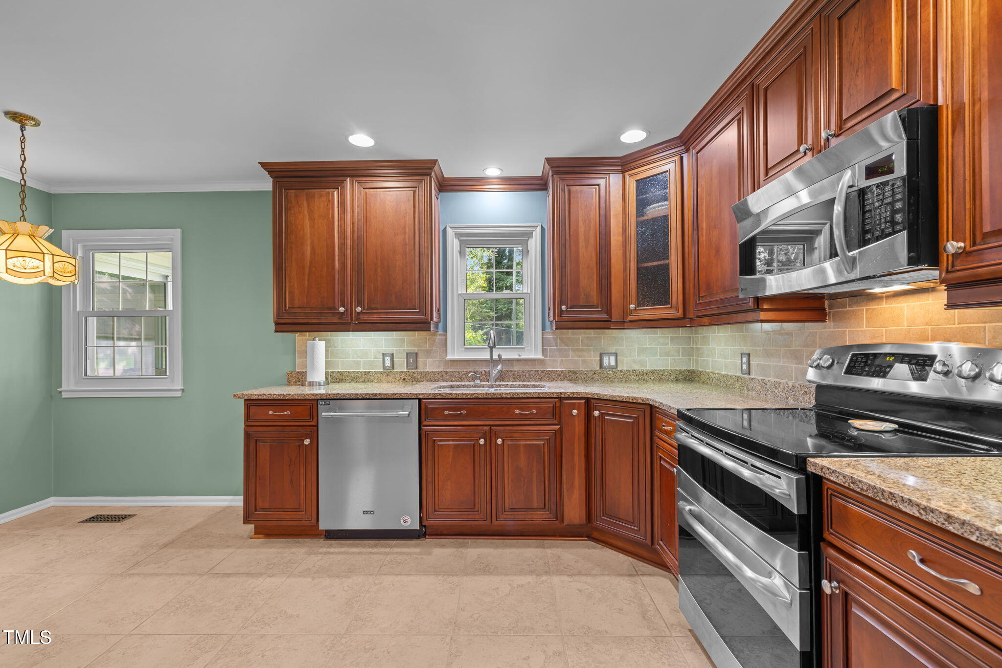 219 Barclay Road Durham, NC 27712 - Photo 8 of 36 a kitchen with stainless steel appliances granite countertop a stove a sink and a microwave