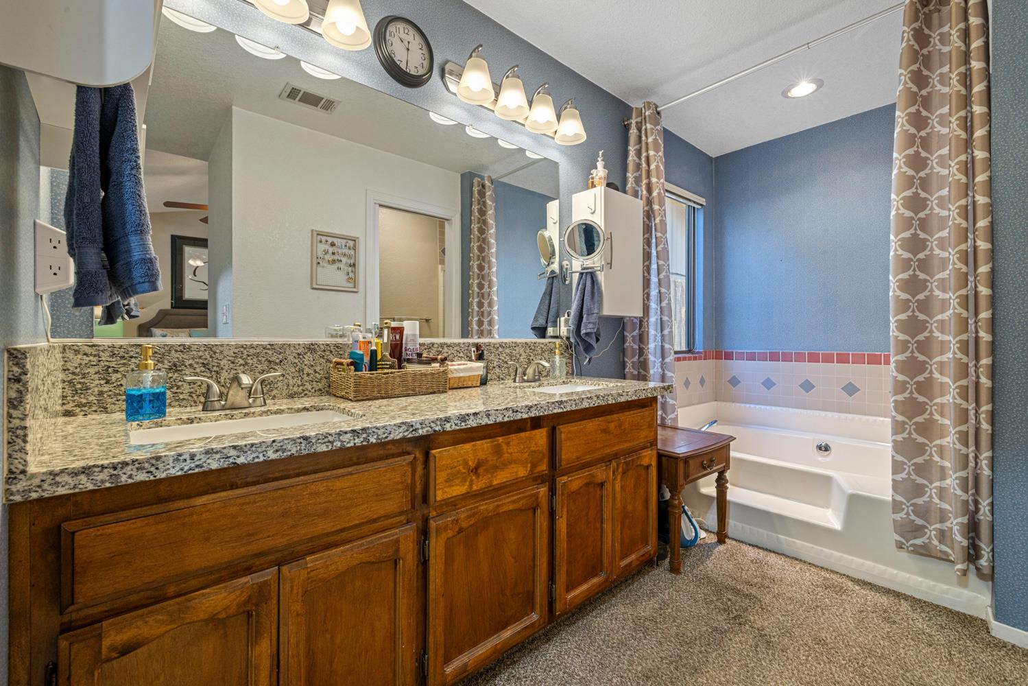 1121 Raymond Drive Modesto, CA 95351 - Photo 22 of 44 a bathroom with a sink double vanity granite and a mirror