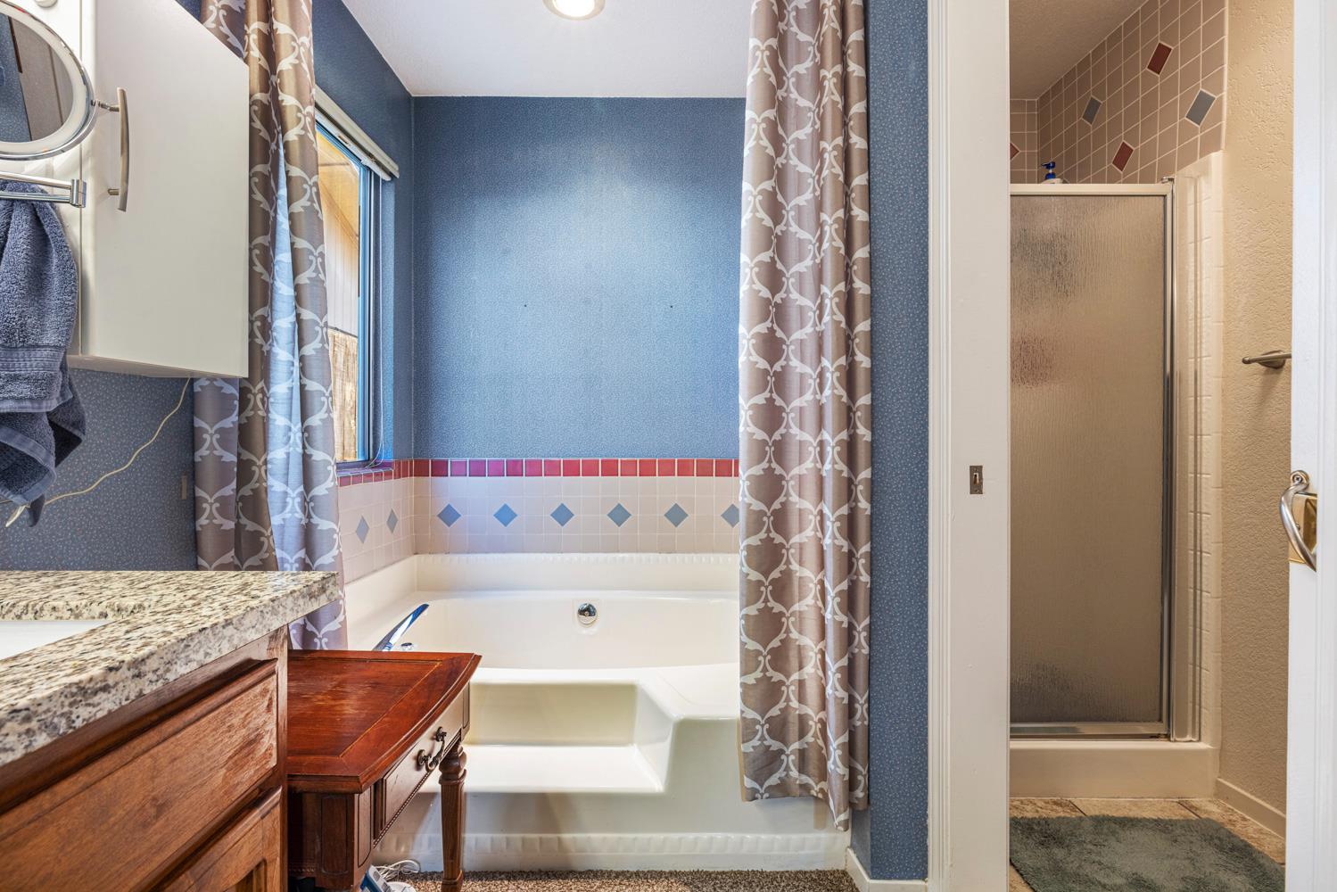 1121 Raymond Drive Modesto, CA 95351 - Photo 23 of 44 a bathroom with a bathtub and a shower