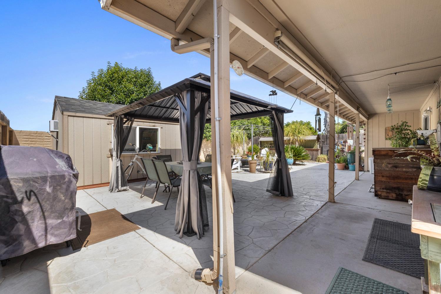 1121 Raymond Drive Modesto, CA 95351 - Photo 36 of 44 a view of a patio with a table and chairs next to a window
