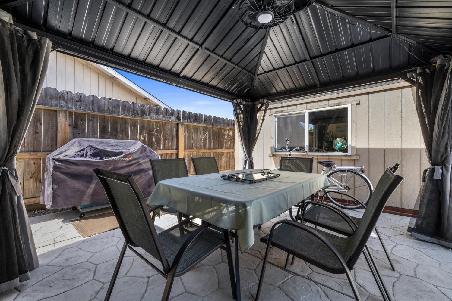 1121 Raymond Drive Modesto, CA 95351 - Photo 37 of 44 a view of a patio with a table and chairs