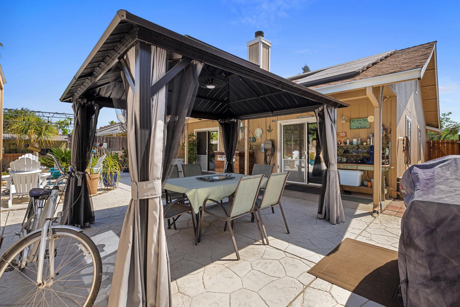 1121 Raymond Drive Modesto, CA 95351 - Photo 38 of 44 a view of a patio with table and chairs and potted plants