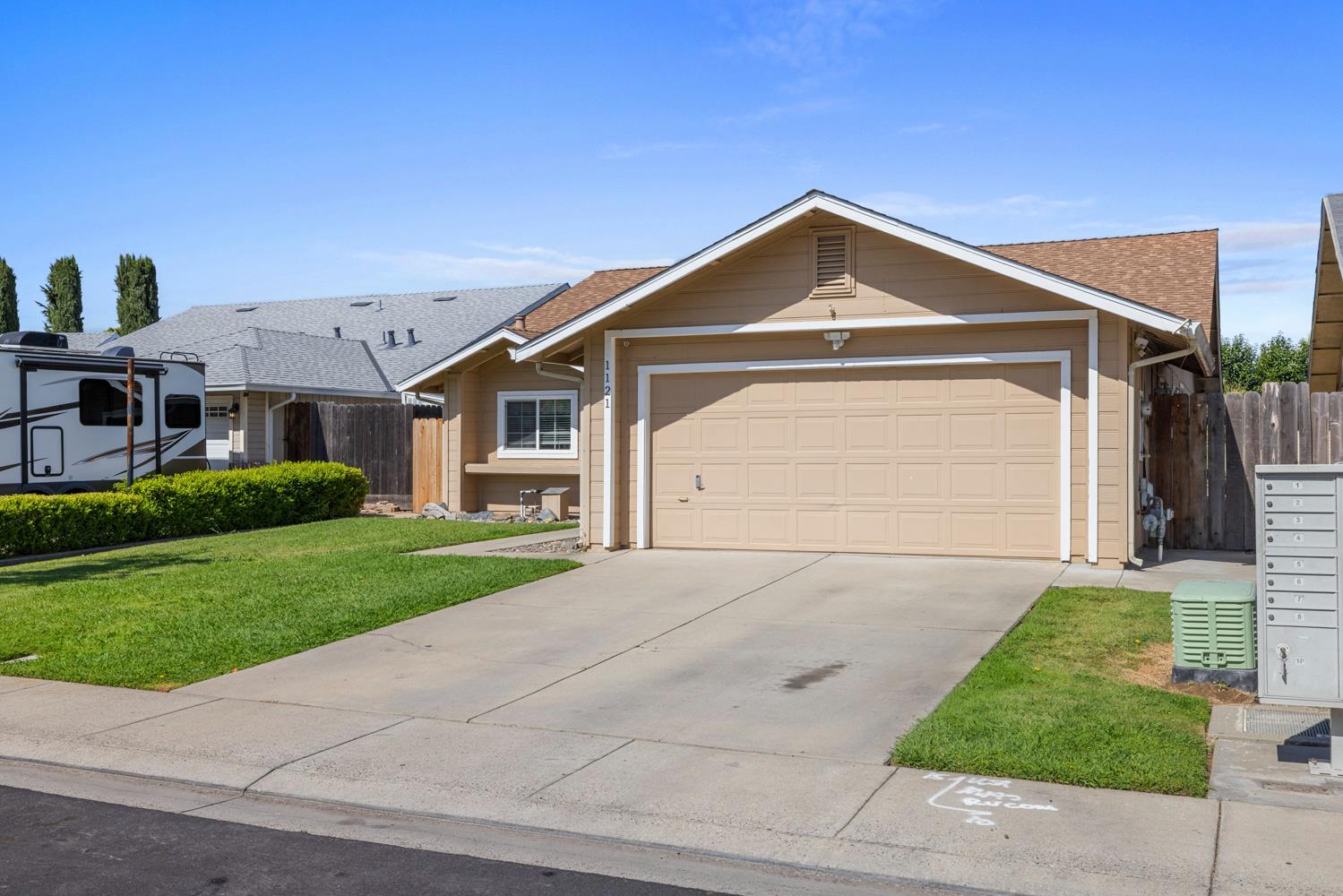 1121 Raymond Drive Modesto, CA 95351 - Photo 4 of 44 a front view of a house with a yard and garage