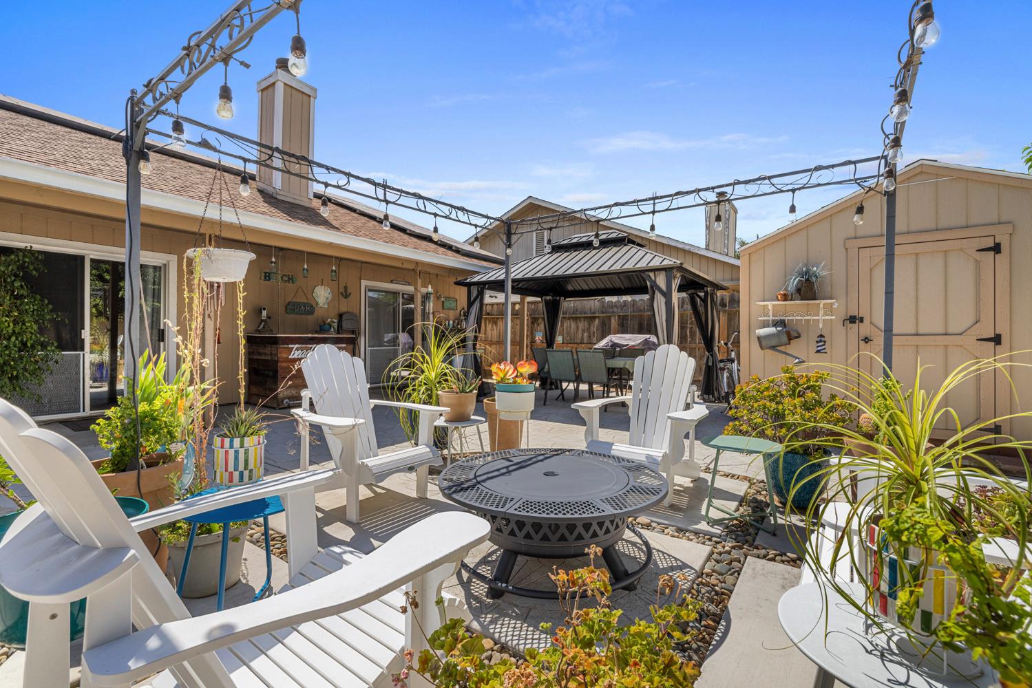 1121 Raymond Drive Modesto, CA 95351 - Photo 41 of 44 a view of a patio with table and chairs potted plants