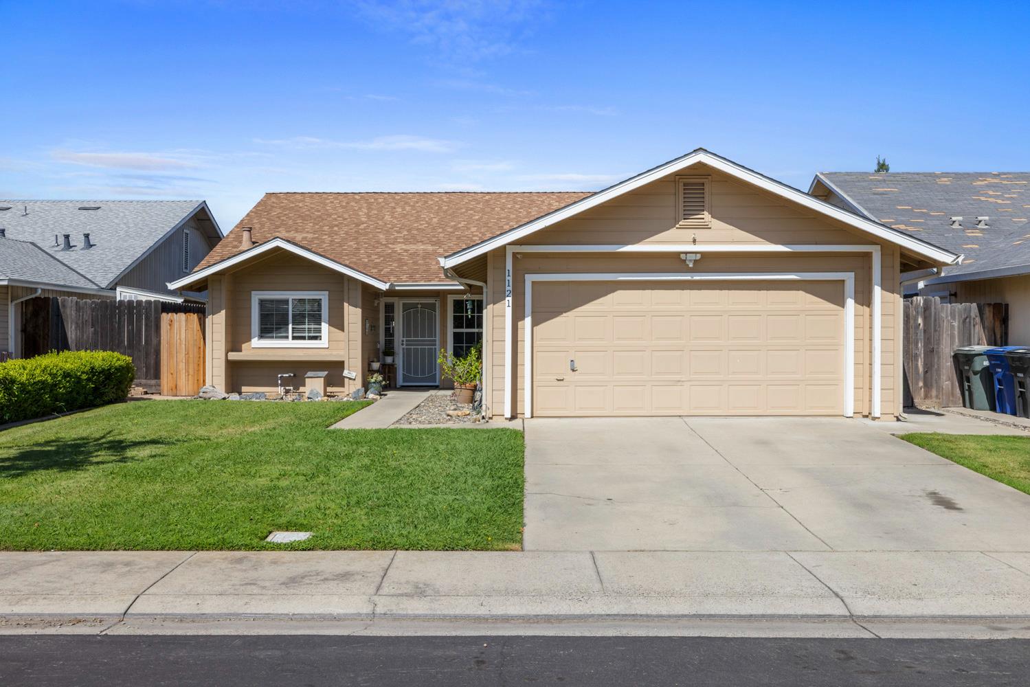 1121 Raymond Drive Modesto, CA 95351 - Photo 5 of 44 a front view of a house with a yard