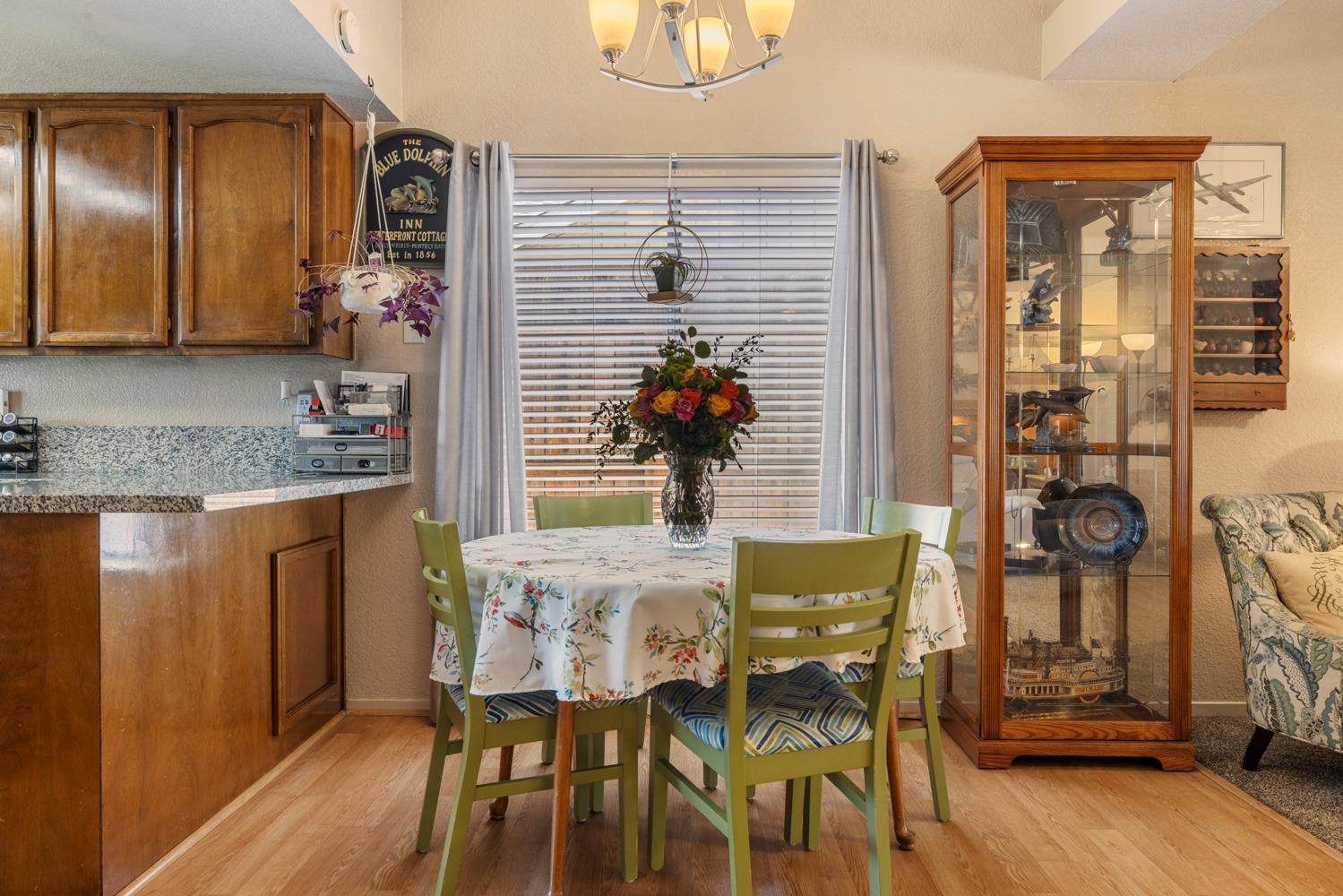 1121 Raymond Drive Modesto, CA 95351 - Photo 9 of 44 a view of a dining room with furniture and wooden floor