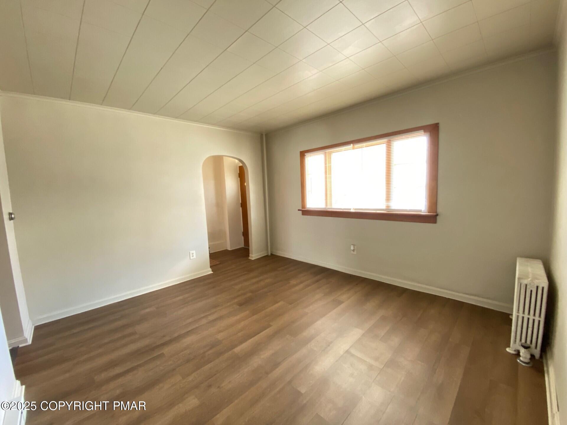 36 East Fell Street Summit Hill, PA 18250 - Photo 8 of 44 an empty room with wooden floor and windows