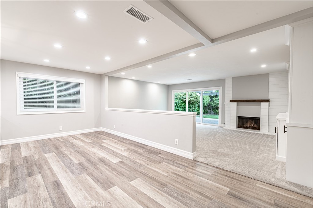 4580 Hazelnut Avenue Seal Beach, CA 90740 - Photo 14 of 34 a view of empty room with fireplace and wooden floor