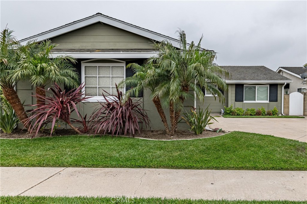 4580 Hazelnut Avenue Seal Beach, CA 90740 - Photo 2 of 34 a front view of a house with a yard