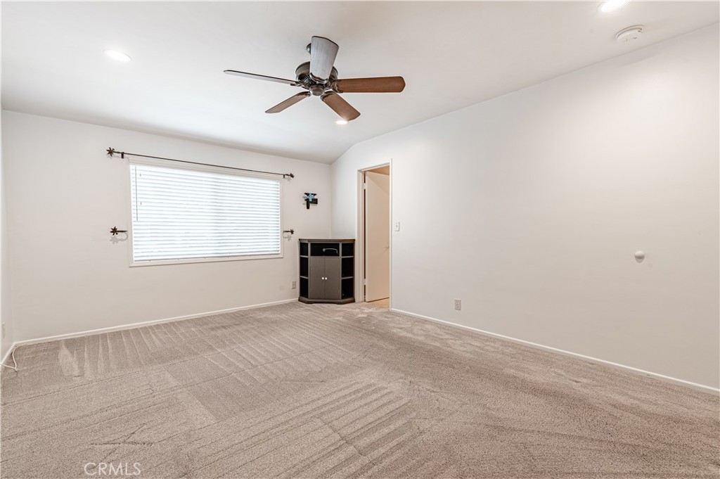 4580 Hazelnut Avenue Seal Beach, CA 90740 - Photo 21 of 34 a view of empty room with a ceiling fan and window
