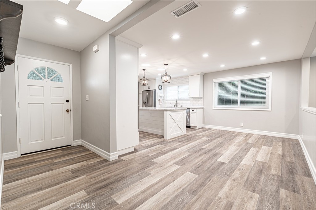 4580 Hazelnut Avenue Seal Beach, CA 90740 - Photo 3 of 34 a view of a kitchen with wooden floor and a window