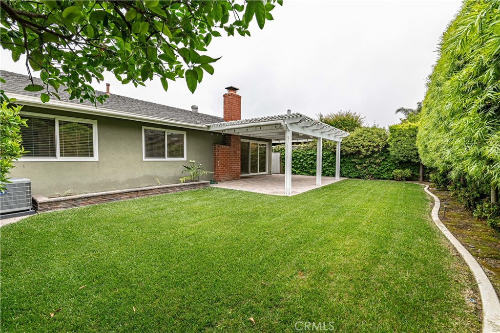 4580 Hazelnut Avenue Seal Beach, CA 90740 - Photo 31 of 34 a view of a house with backyard and a tree