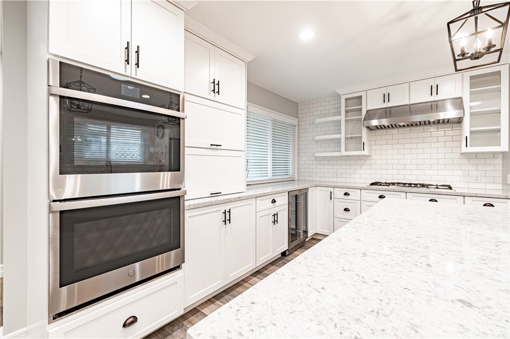 4580 Hazelnut Avenue Seal Beach, CA 90740 - Photo 6 of 34 a kitchen with stainless steel appliances a stove microwave and cabinets