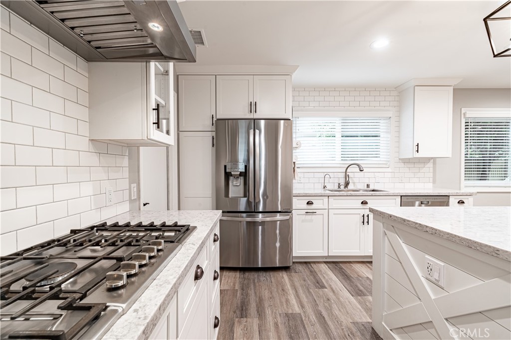 4580 Hazelnut Avenue Seal Beach, CA 90740 - Photo 8 of 34 a kitchen with a stove a refrigerator and a sink