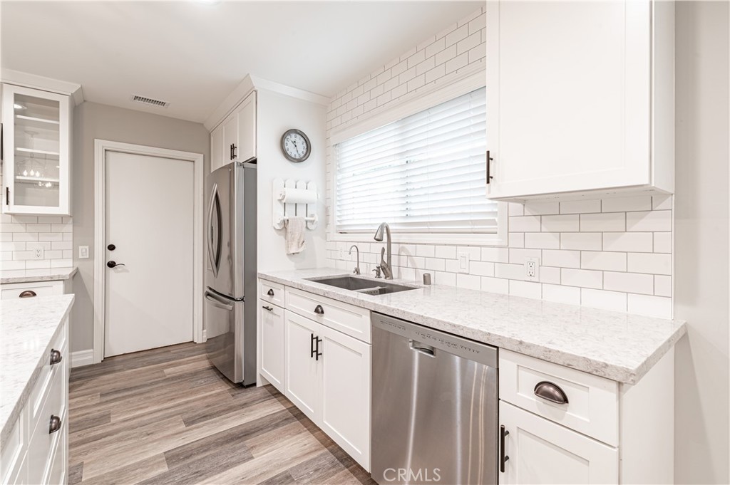 4580 Hazelnut Avenue Seal Beach, CA 90740 - Photo 10 of 34 a kitchen with a sink stove and refrigerator
