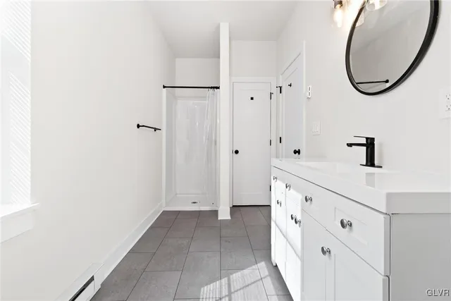 a bathroom with granite countertop a sink a toilet and a mirror
