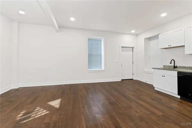 a view of a kitchen with a sink and a stove top oven