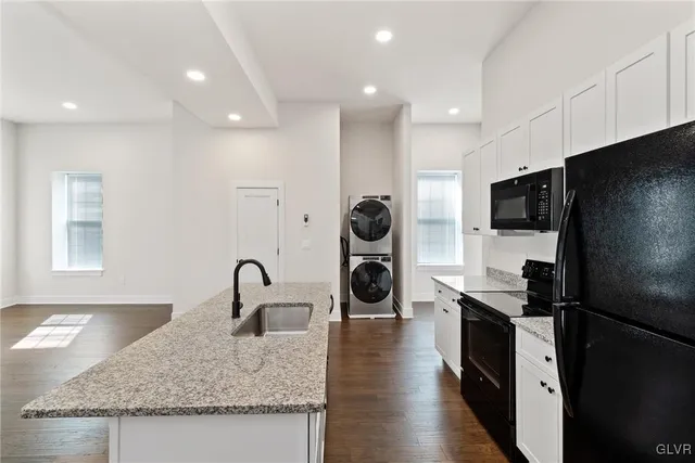 a kitchen with stainless steel appliances a refrigerator and a stove top oven