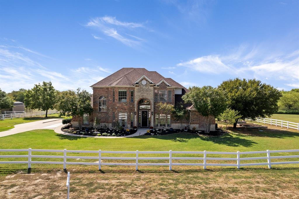 901 Creek Hollow Lane Fort Worth, TX 76131 - Photo 1 of 33 a front view of a house with a yard