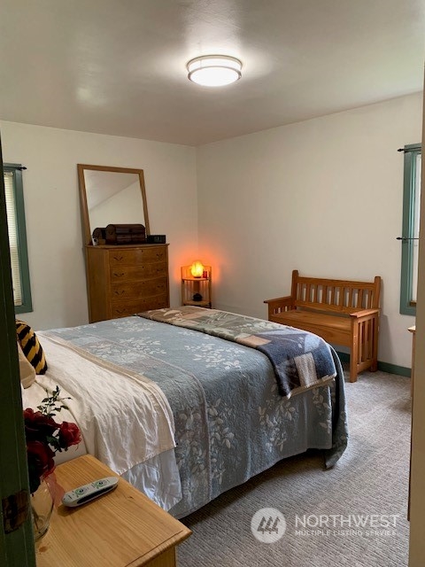 7634 Zell Road Custer, WA 98240 - Photo 15 of 38 a bedroom with a bed and a lamp with the dresser