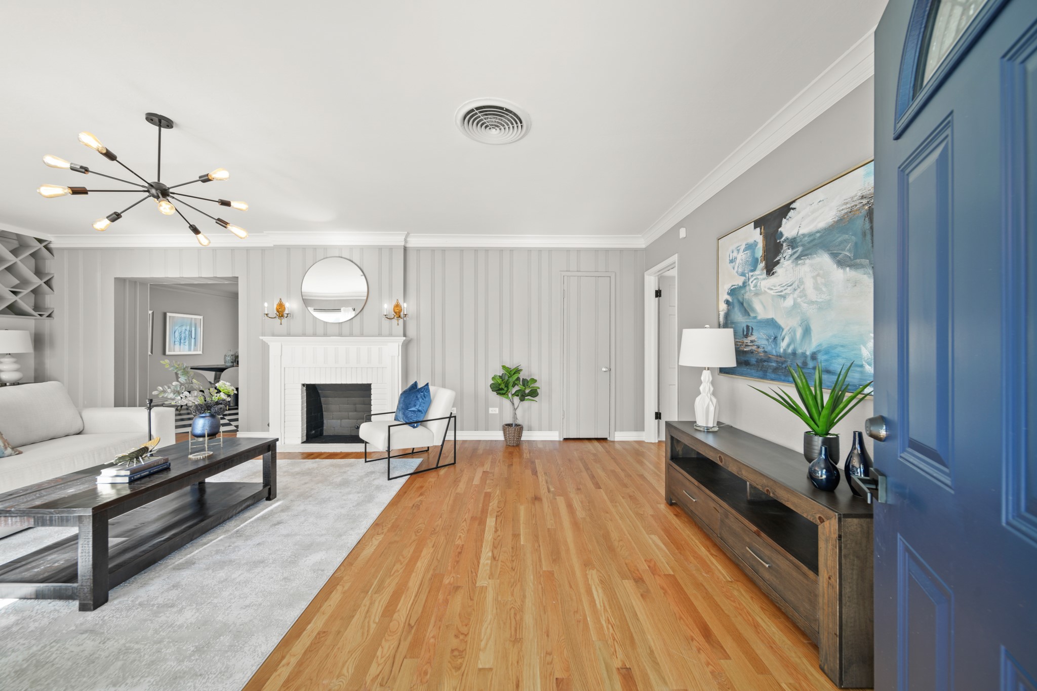 4391 Varsity Lane Houston, TX 77004 - Photo 5 of 45 a living room with furniture a fireplace and a chandelier