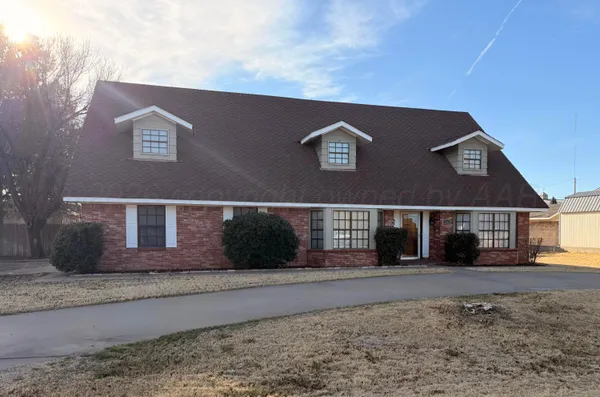 a view of a brick house with large windows