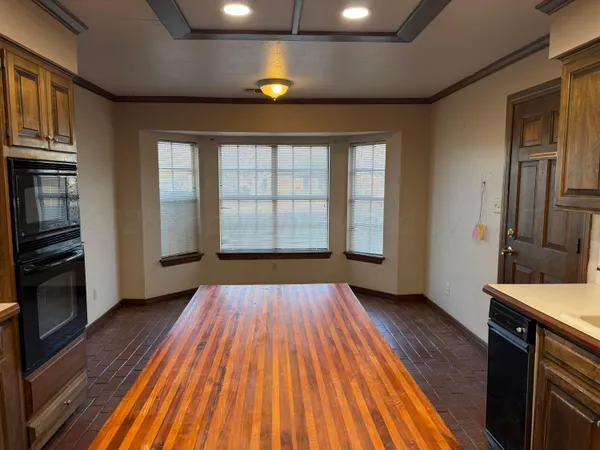 a view of a room with wooden floor and staircase