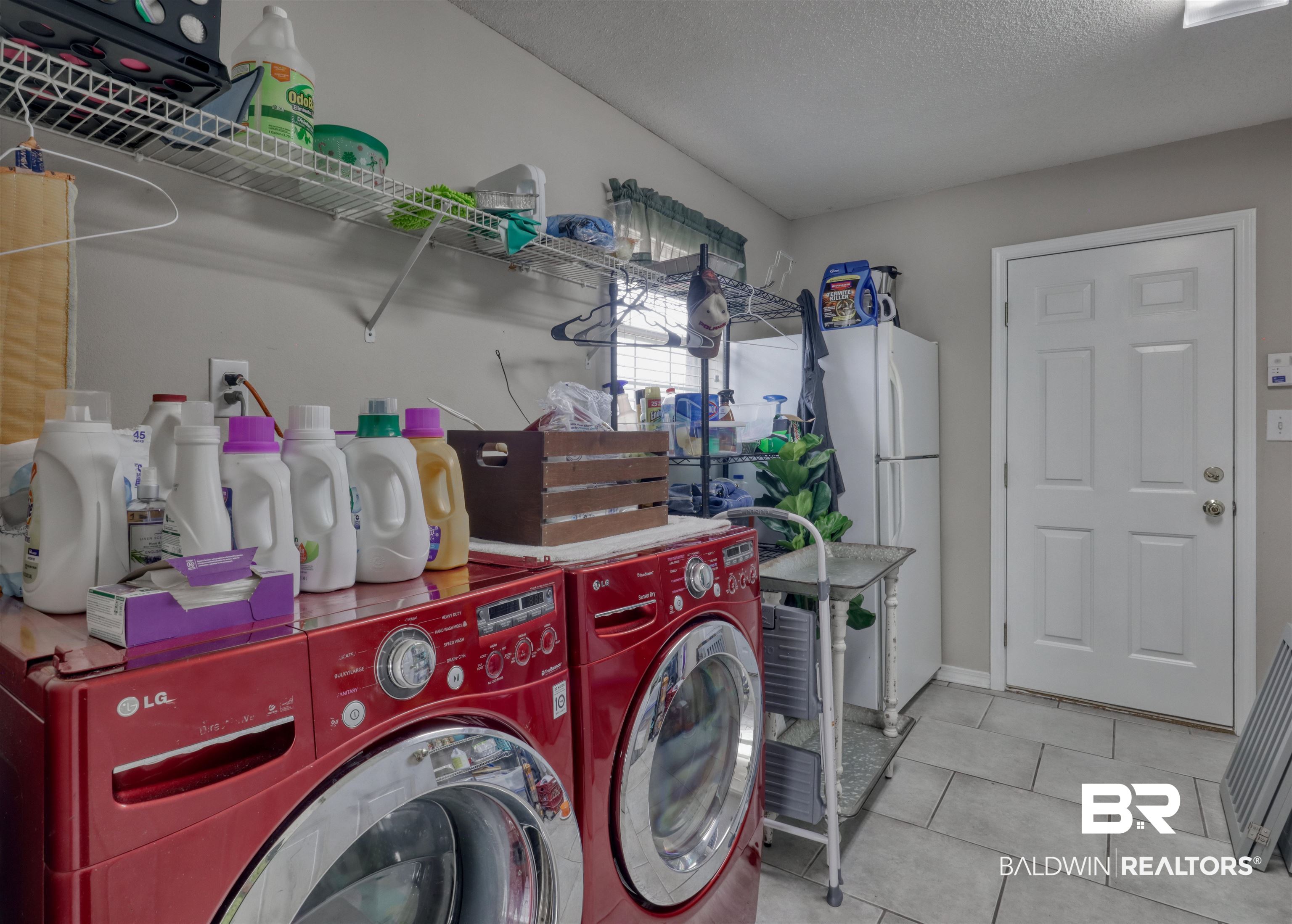 12893 Hunters Chase Foley, AL 36535 - Photo 34 of 42 Laundry room featuring washer and clothes dryer, a textured ceiling, laundry area, and tile patterned floors