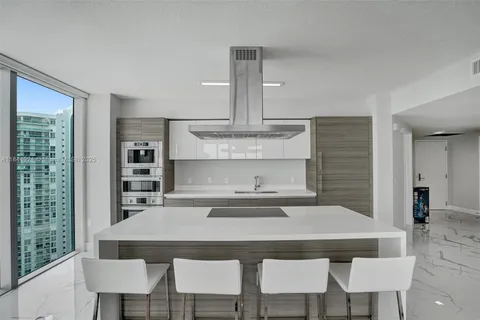a kitchen with a dining table and chairs